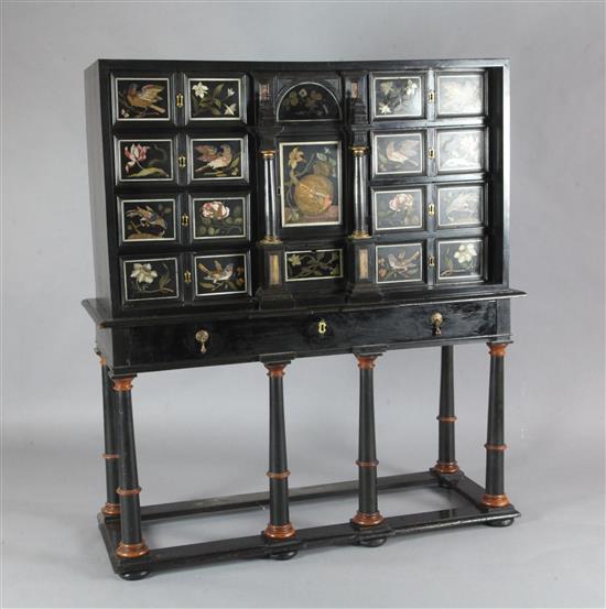 A 17th/18th century Italian and later pietra dura and ebony veneered cabinet on an ebonised wood stand, W.4ft 2in. D.1ft 7in. H.4ft 6.5